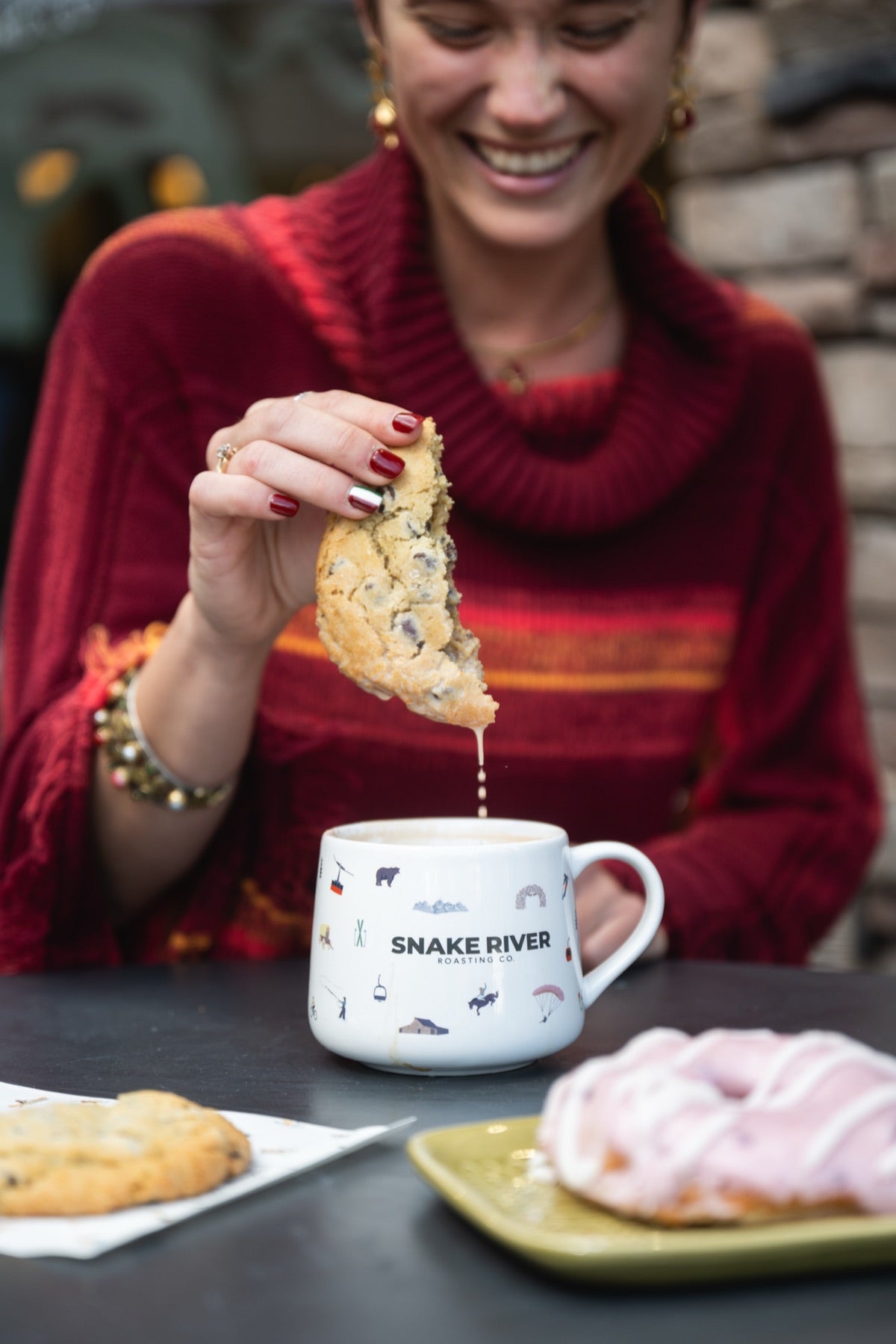Dipping a cookie into a Snake River mug