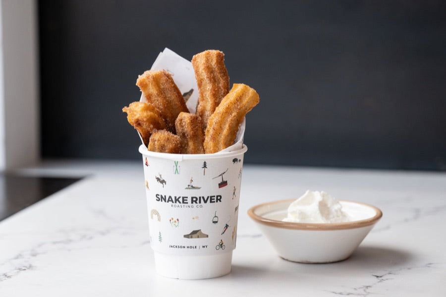 Cinnamon churros in a Snake River cup
