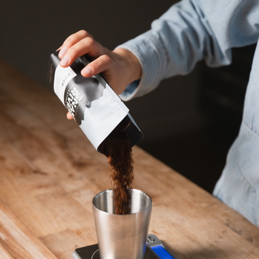 Pouring whole beans from the bag at a campsite