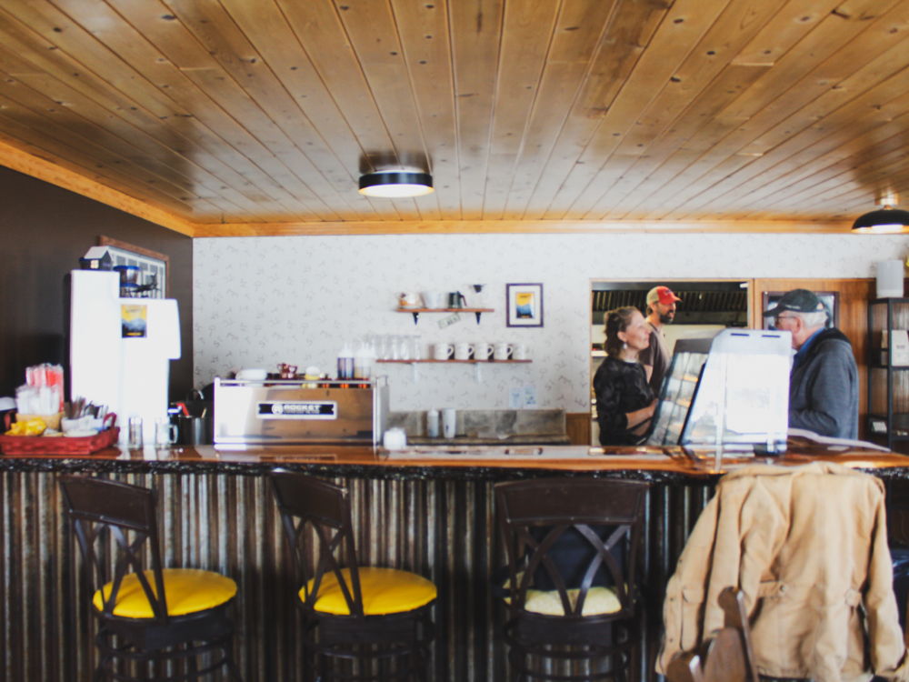 The cafe bar inside Branding Iron with stools and pendant lights