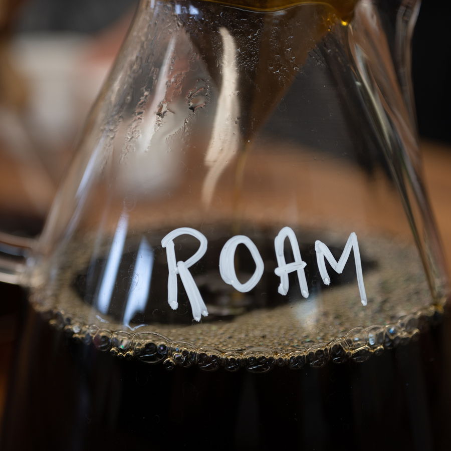 A chemex of our Roam blend mid-brew with the logo showing