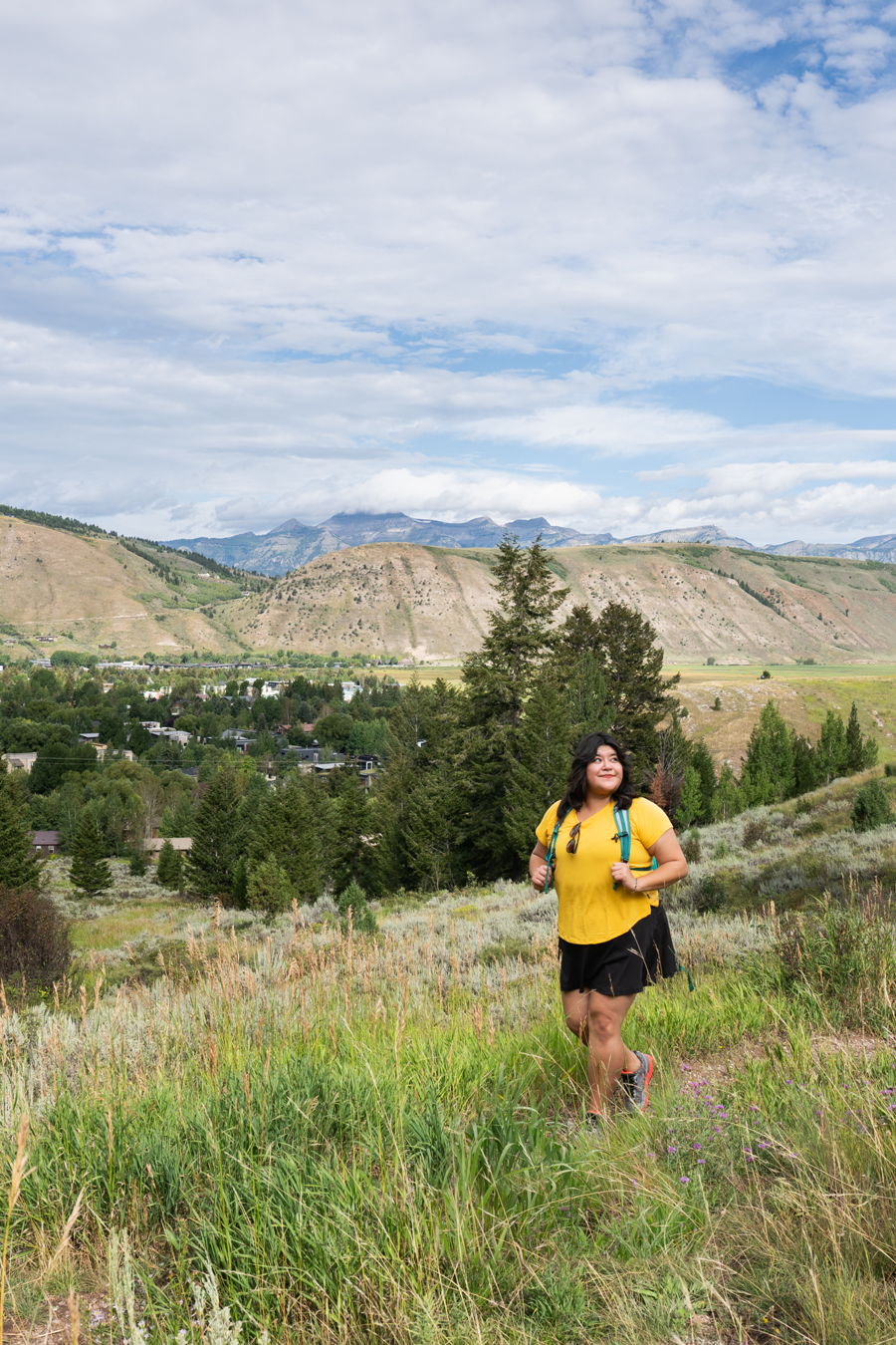 Hiking through a meadow above the valley